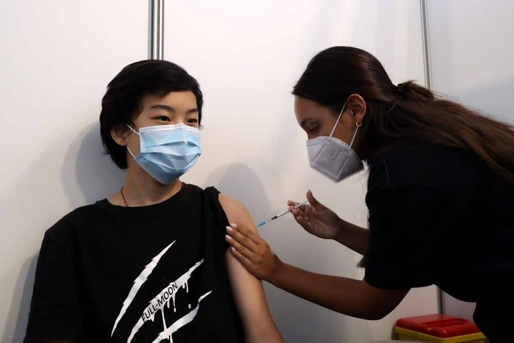 A boy receives his first dose of the COVID-19 vaccine at a vaccination center in Oeiras, Portugal.