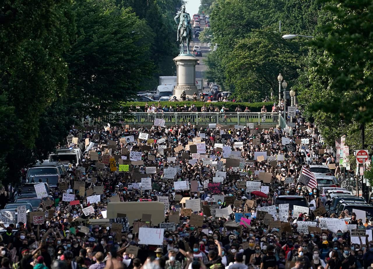 Hundreds of demonstrators march toward Lafayette Park and the White House to protest against police brutality and the death of George Floyd.