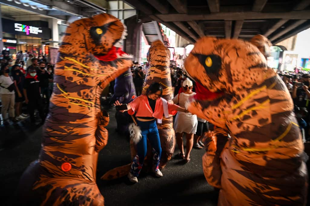 Protesters wear dinosaur costumes in the Siam area on 21 November, 2020 in Bangkok, Thailand.