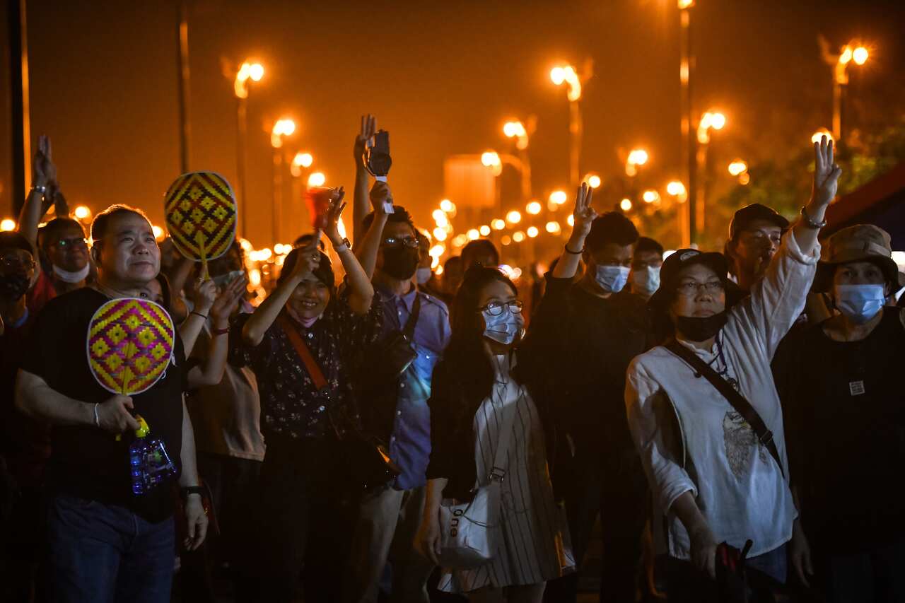 Protesters demanding constitutional reforms make three finger salutes in on November 22 in Bangkok, Thailand.