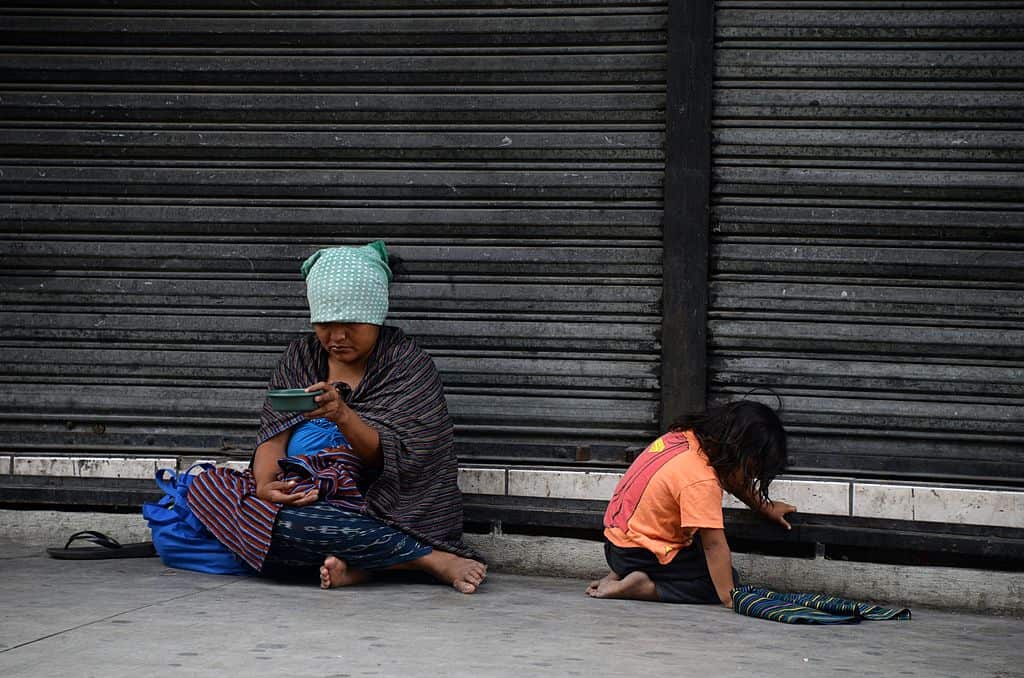 An indigenous woman with her child begs for money on the streets of the historic centre of Guatemala City, on May 31, 2014. AFP PHOTO Johan ORDONEZ (Photo credit should read JOHAN ORDONEZ/AFP/Getty Images)