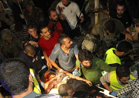 Emergency personnel remove a body from the site of a twin suicide bombing in Burj al-Barajneh, in the southern suburbs of the capital Beirut on November 12, 2015. (ANWAR AMRO/AFP/Getty Images)