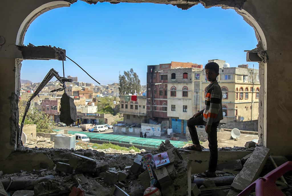 A Yemeni boy among the damage in the country's southern city of Taez following a mortar shell attack in February 2016.