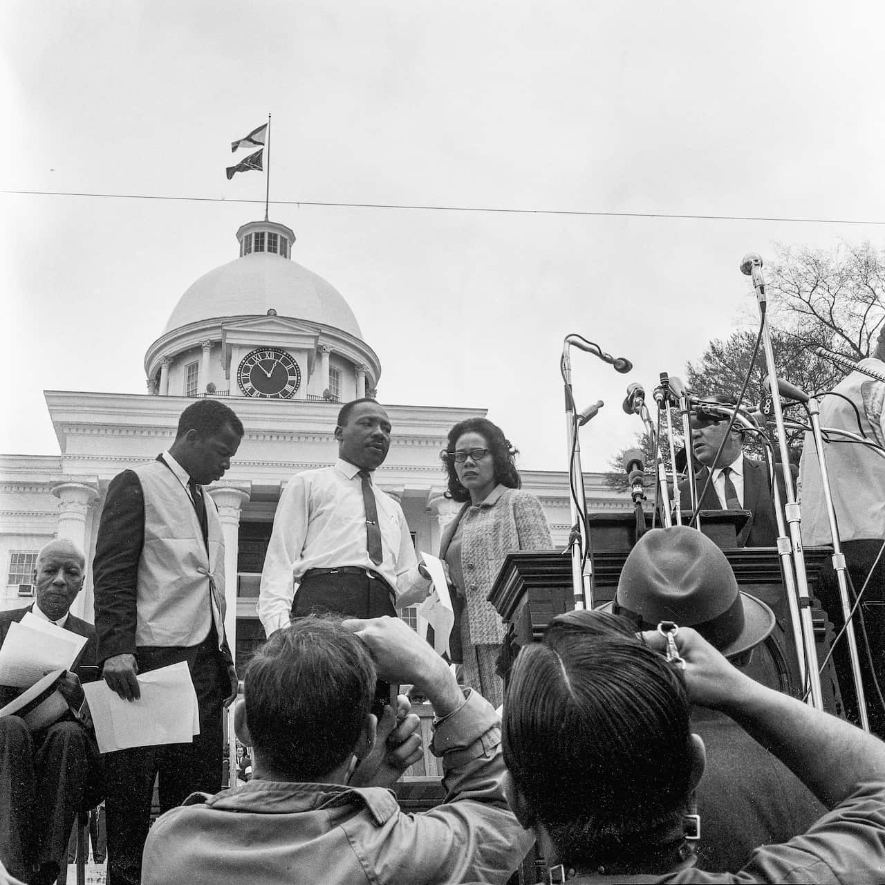 American religious and civil rights leaders John Lewis, Martin Luther King Jr and Coretta Scott King are seen on the steps of the Alabama State Capitol in 1965.