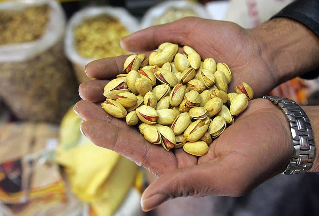 A pistachio wholesaler shows his goods at his shop in Tehran. 