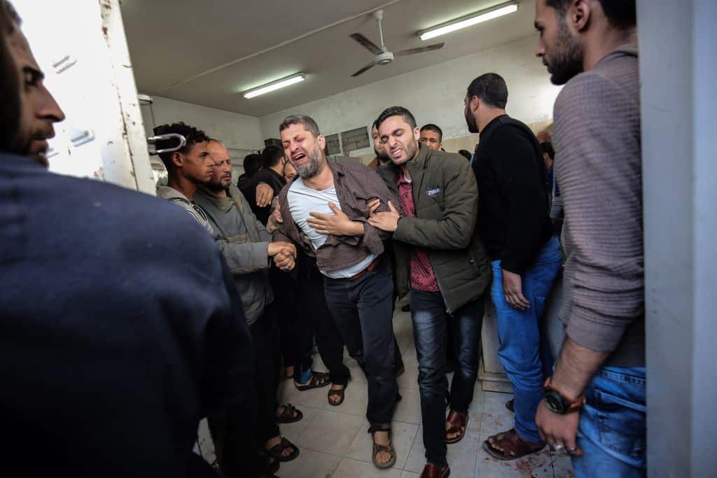 Palestinian relatives of a man who died in an explosion east of Rafah in the southern Gaza Strip, mourn at the Najjar hospital in Rafah on April 14, 2018.