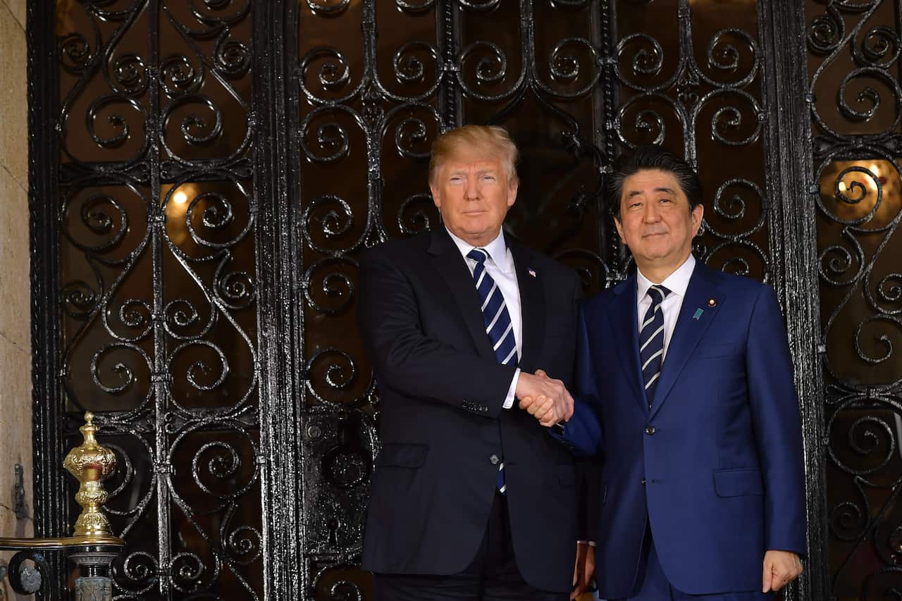 US President Donald Trump greets Japanese Prime Minister Shinzo Abe as he arrives for talks at Trump's Mar-a-Lago resort in Palm Beach, Florida, on April 17, 2018. / AFP PHOTO / MANDEL NGAN (Photo credit should read MANDEL NGAN/AFP/Getty Images)