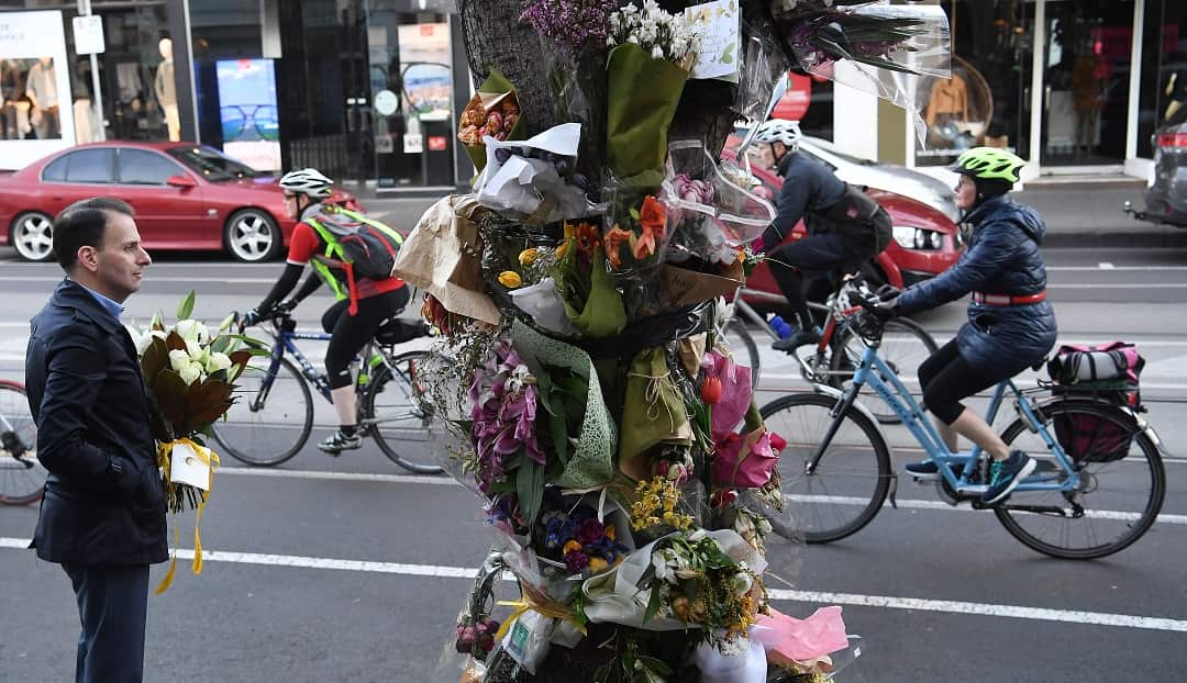 Members of Melbourne's Bicycle Network ride past a memorial for Dutch cyclist Gitta Scheenhouwerrk. 