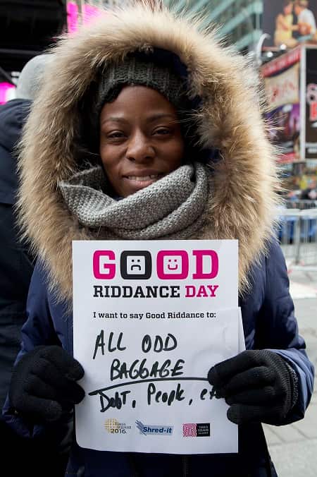Carlita Gibsonholds a sheet of paper listing items she would like to shred and forget during a Good Riddance Day celebration (AP Photo/Mark Lennihan)