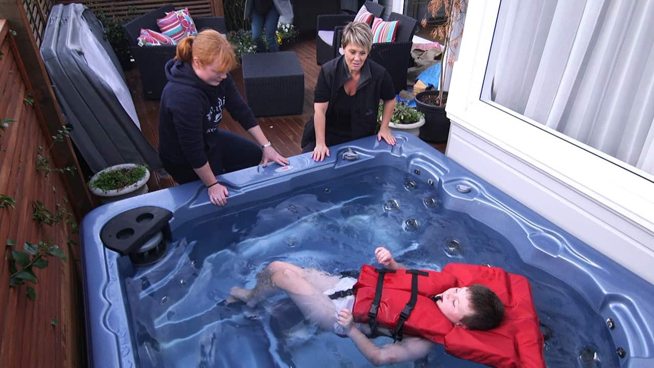 Caleb has cerebral palsy and now needs Shirley and two carers to help get him into the spa pool.