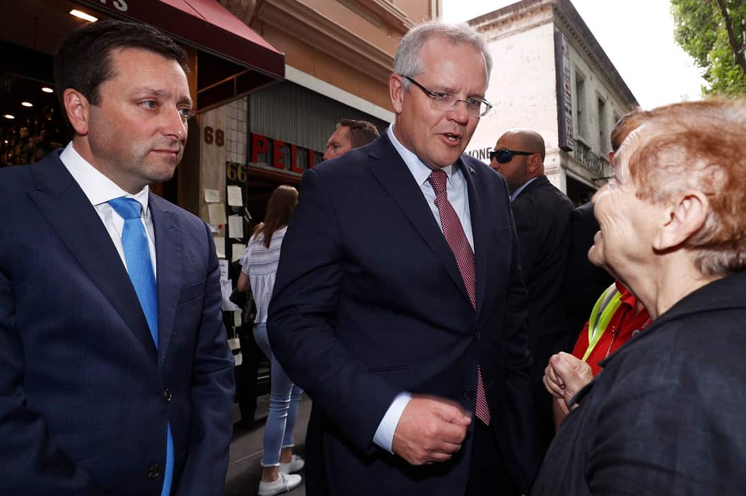 Prime Minister Scott Morrison (centre) and State Opposition leader Matthew Guy (left) greet locals outside Pellegrini's Espresso Bar as it re-opens to the public in Melbourne, Australia, Tuesday, November 13, 2018. (AAP Image/Daniel Pockett) NO ARCHIVING