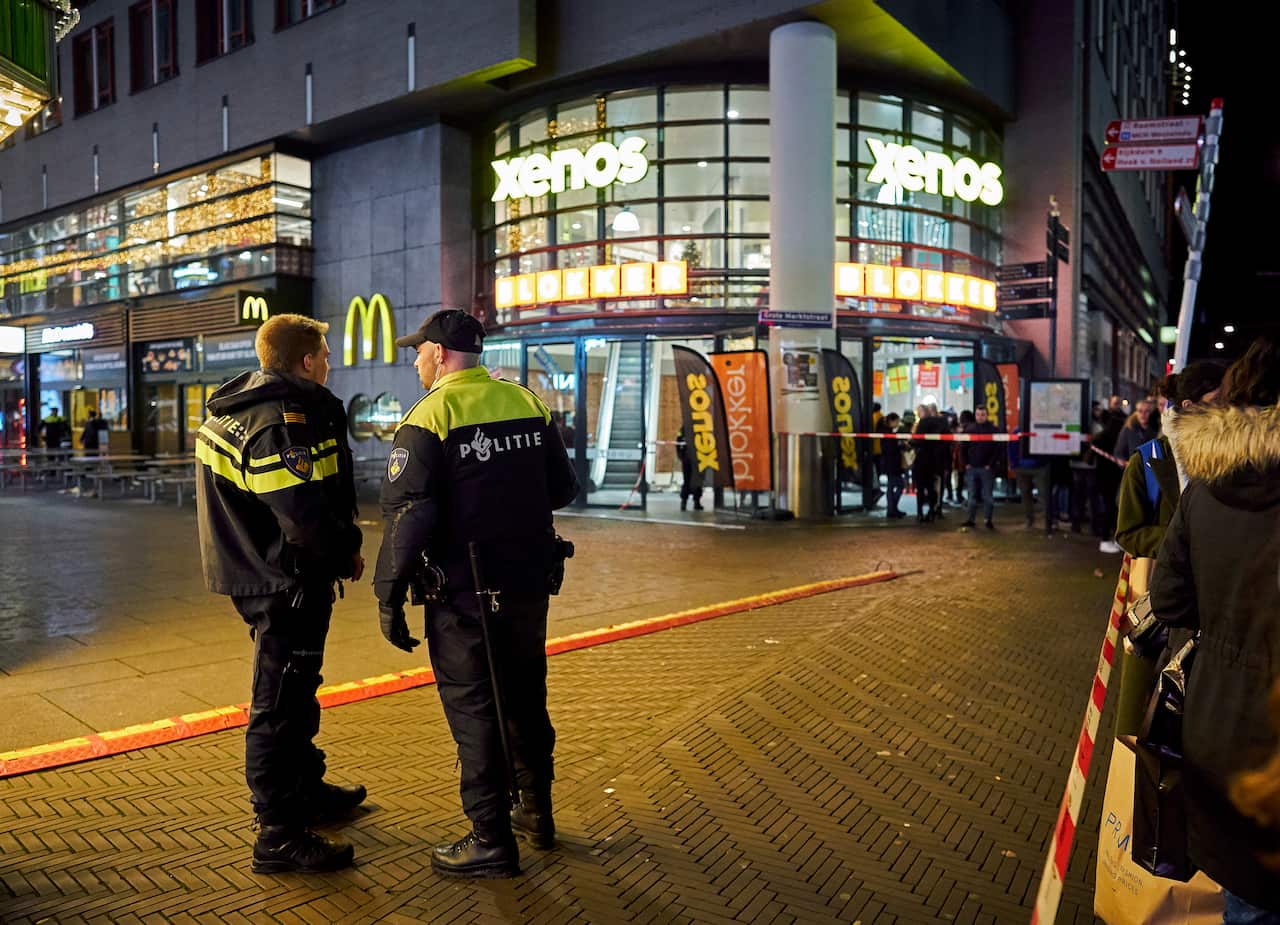 Dutch police secure the shopping street after the stabbing in the centre of The Hague.