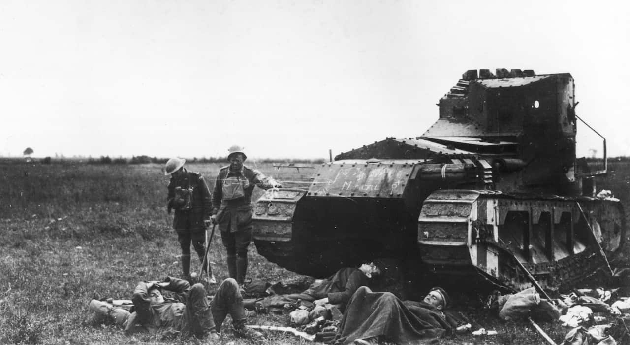 Wounded Australians of the 15th Brigade and German prisoners sheltering beside a British Whippet tank near Harbonnieres in France during World War I in 1918.