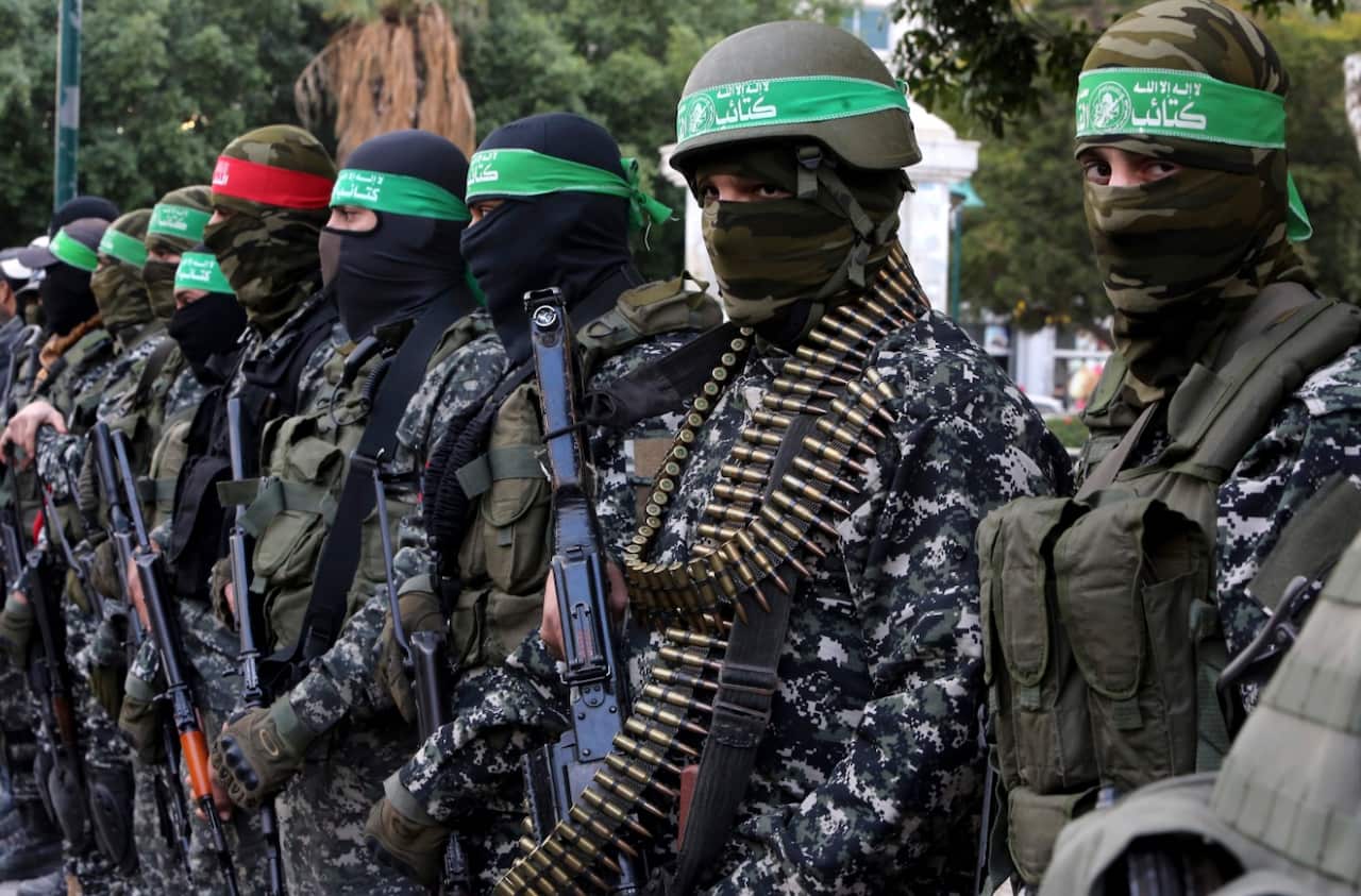 In this Dec. 18, 2016 file photo, masked militants from the Izzedine al-Qassam Brigades, a military wing of Hamas, attend the mourning ceremony