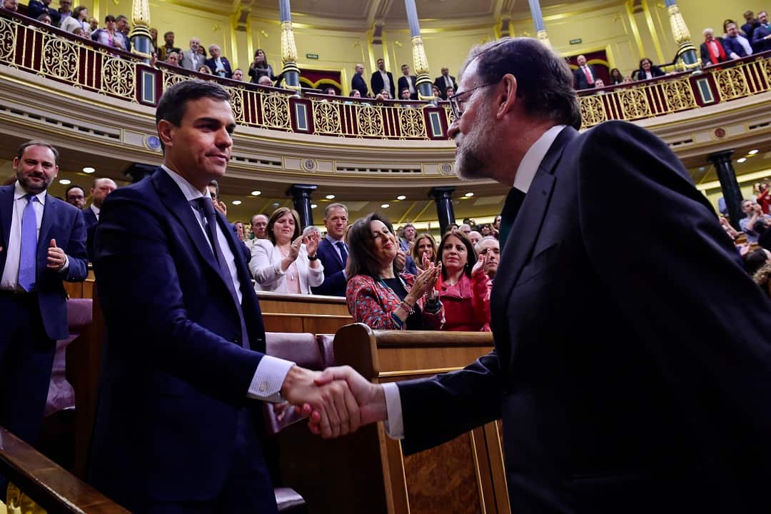 Arch rivals Pedro Sanchez and Mariano Rajoy, right, shake hands ahead of a no confidence motion to oust Rajoy. 