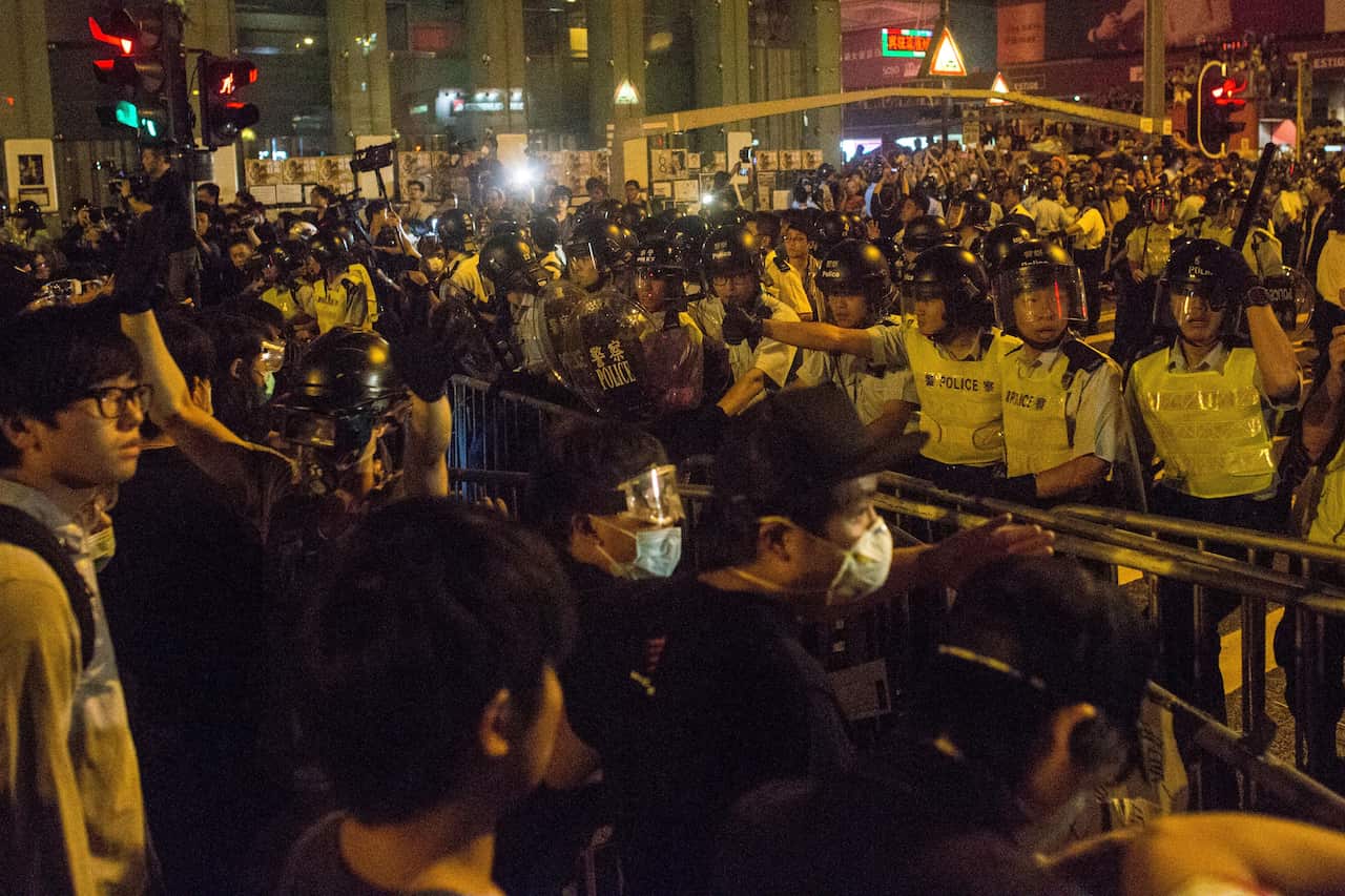 Pro-democracy protesters clash with police on a street in Mong Kok on October 19, 2014 in Hong Kong.