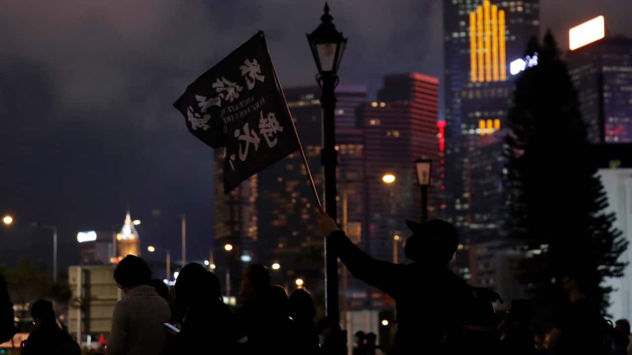 A man waves a flag read "Liberate Hong Kong, Revolution of our times." during a rally in Hong Kong on 30 December 2019.  