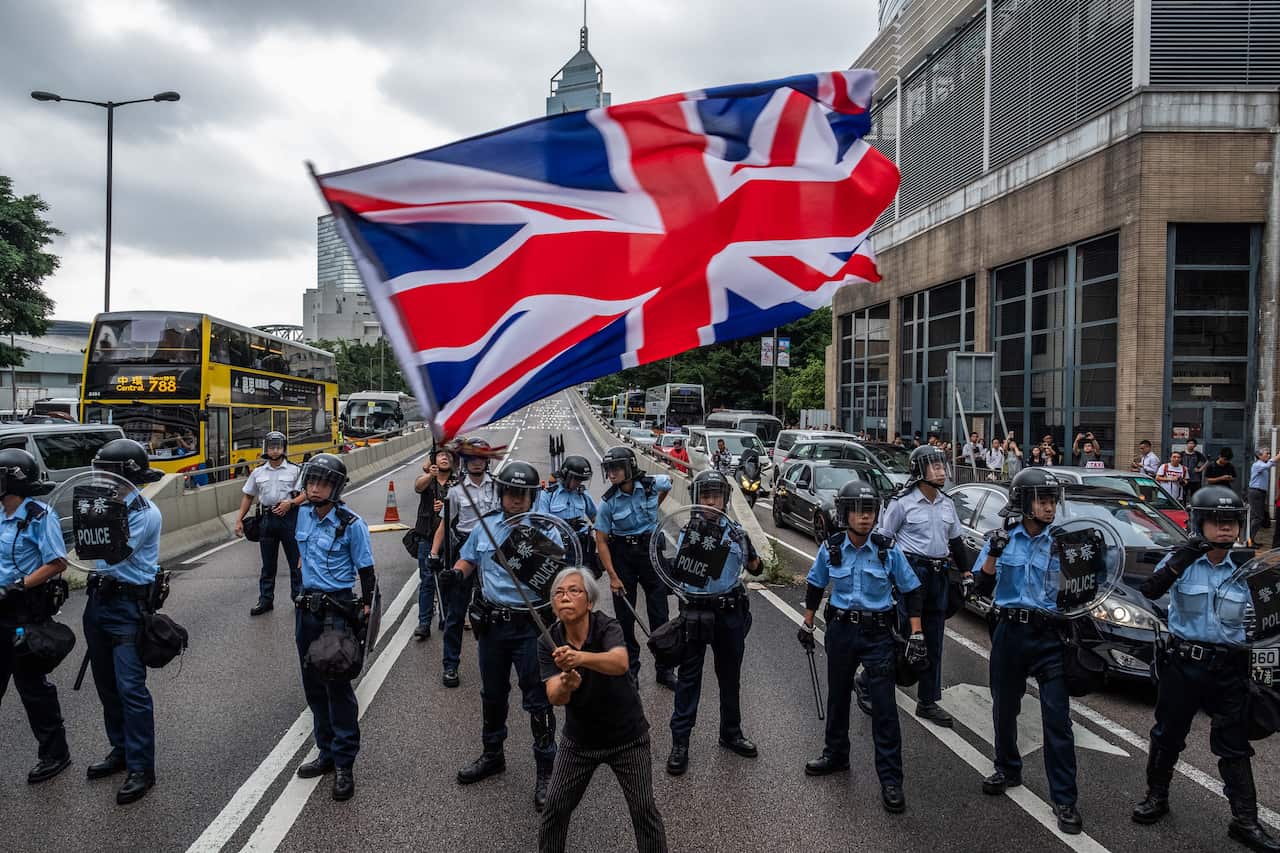 FILE-- Demonstrators clash with riot police outside the Legislative Council building in Hong Kong, June 12, 2019. The Communist Party exerts overwhelming control over media content inside China’s so-called Great Firewall, and it is now using it as a cudge