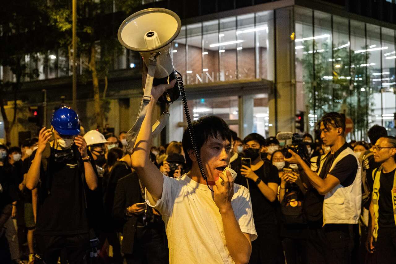 Roy Kwong, a politician, addresses demonstrators who surrounded the police headquarters. Kwong has emerged as a hero for the city’s youth and a leading voice for moderation during the political crisis there.