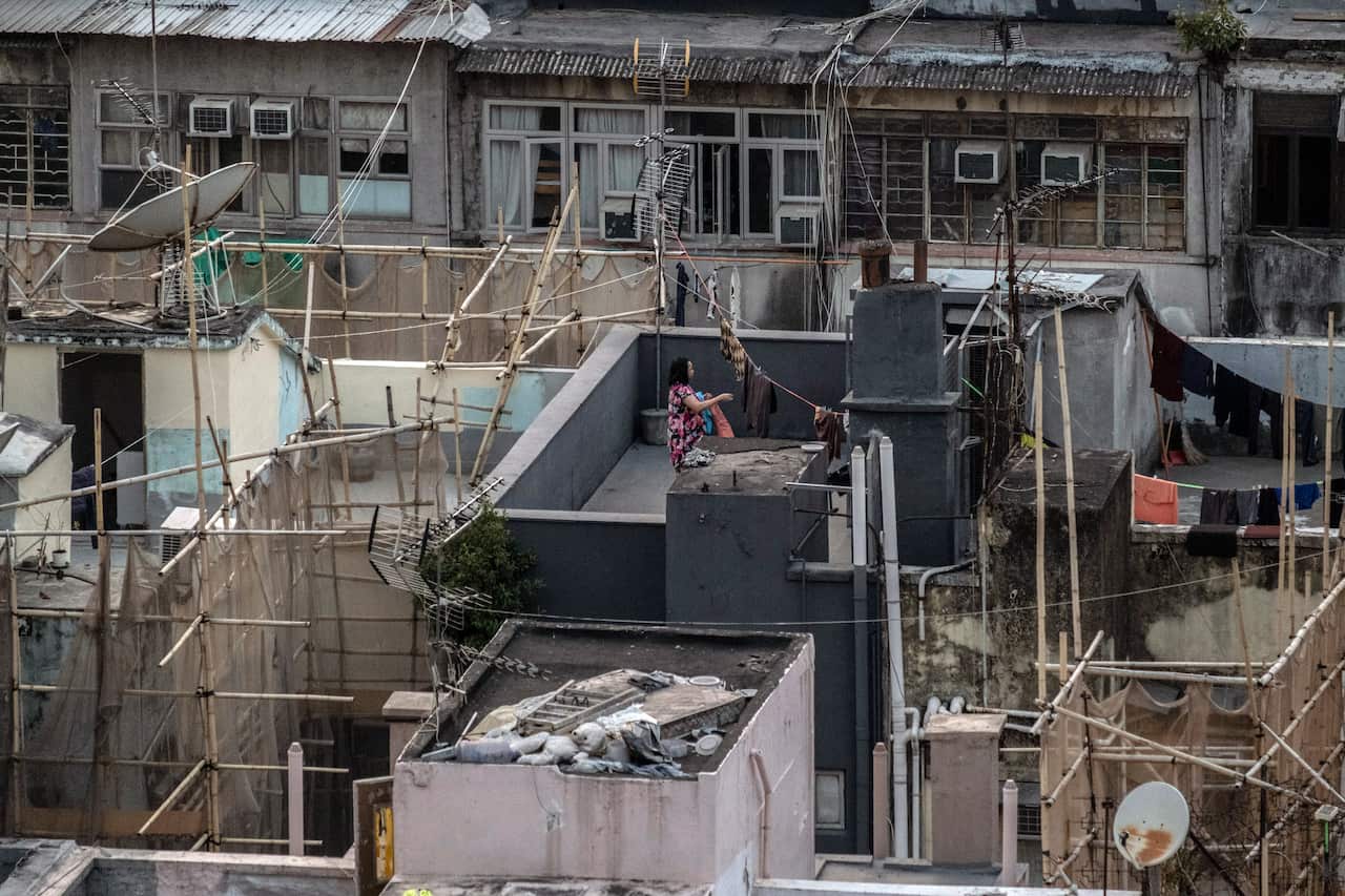 A woman hangs laundry to dry on a rooftop in the Jordan neighbourhood of Hong Kong on Saturday, Jan. 23 2021.