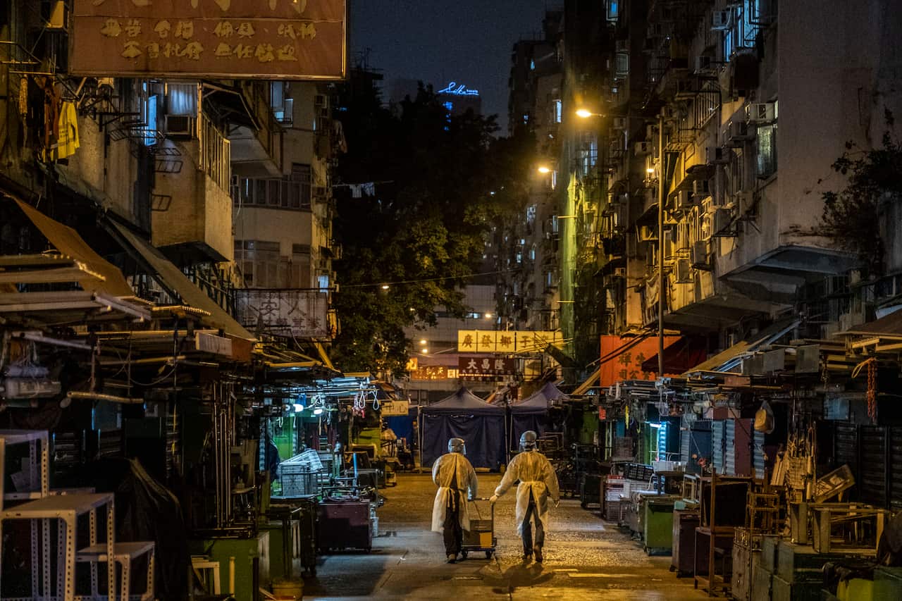 Health authorities in personal protective equipment in Jordan, a working-class neighbourhood in Hong Kong, on Saturday, Jan. 23, 2021.