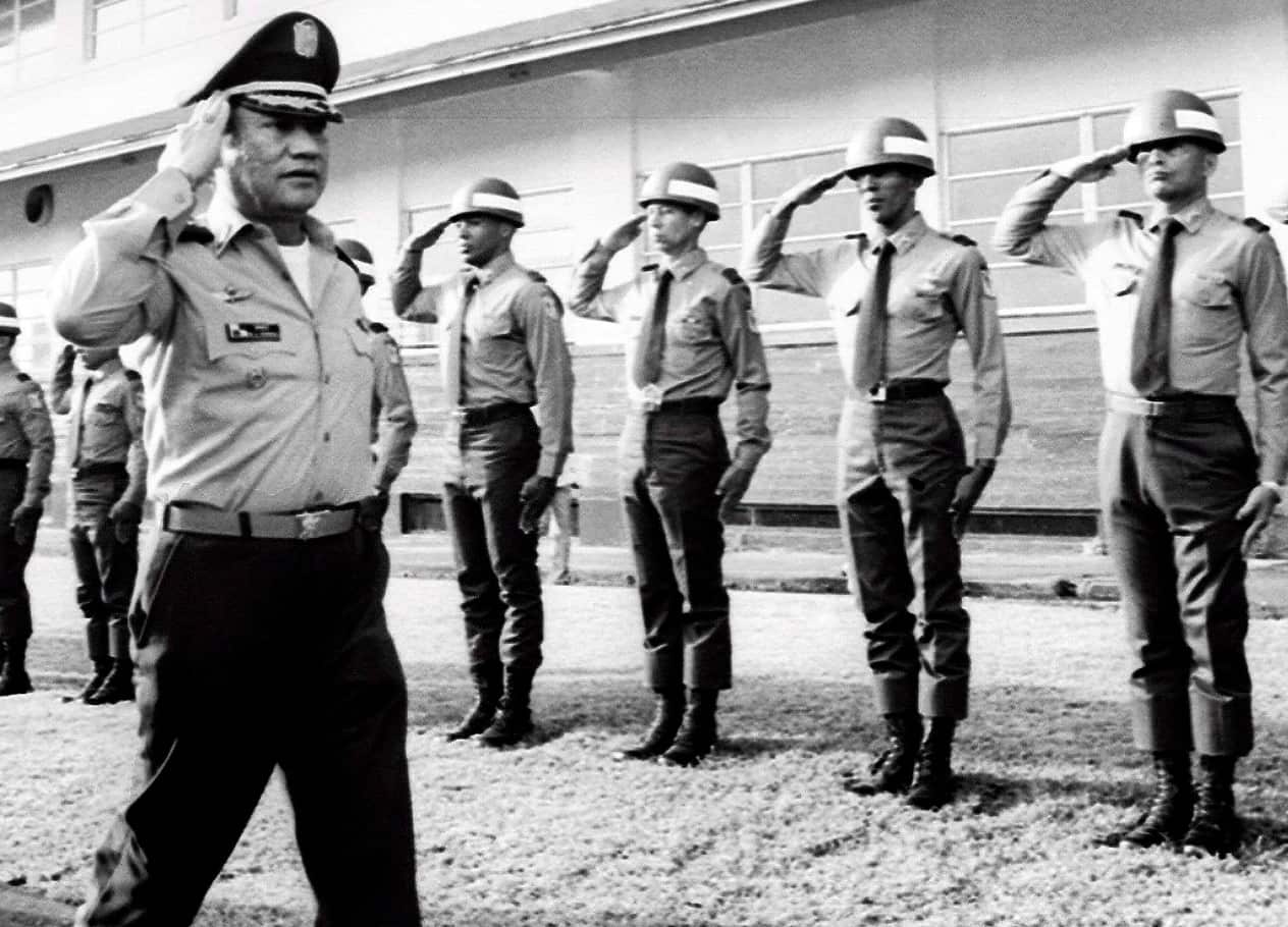 Panamanian dictator Manuel Antonio Noriega (L) salutes troops at an undisclosed location in Panama, 1985 (reissued 30 May 2017). (AAP)