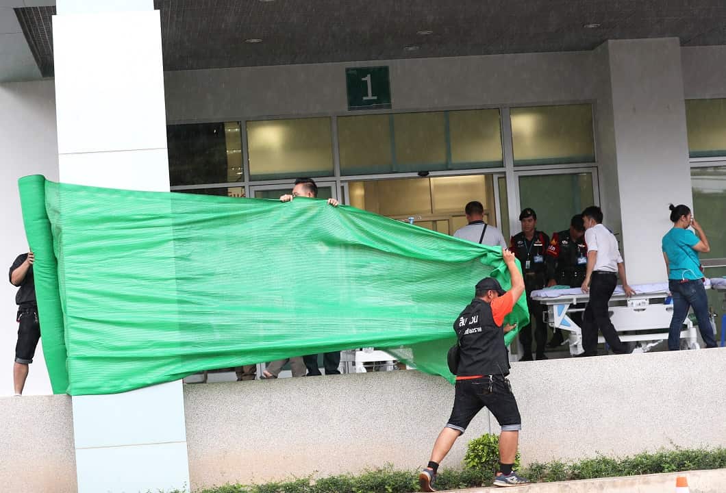 Workers seal off the ambulance arrival area to block media as they prepare for the arrival of the boys and their coach.