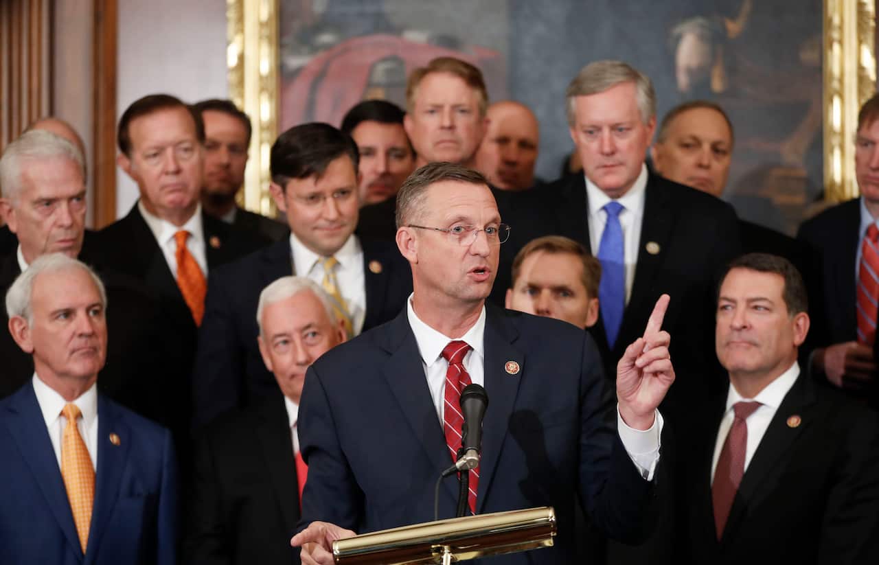 Rep. Doug Collins is joined by fellow Republican politicians after Democrats pushed ahead a package of ground rules for their inquiry.