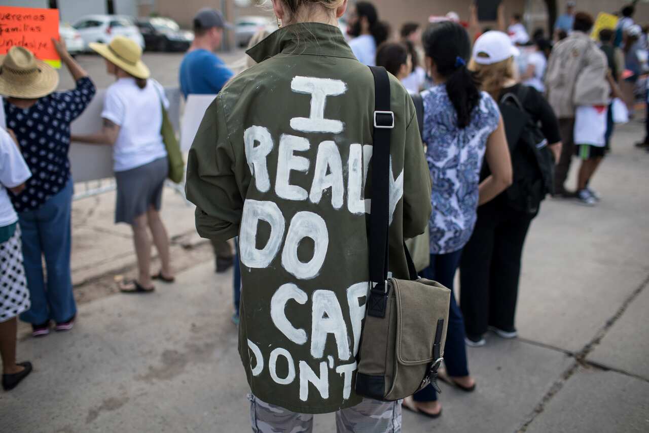 A demonstrator in a jacket referencing one first lady Melania Trump wore on a visit to McAllen, Texas. 