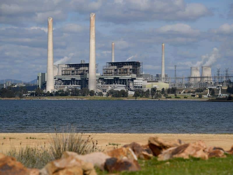A power station as seen from the other side of a large body of water. 