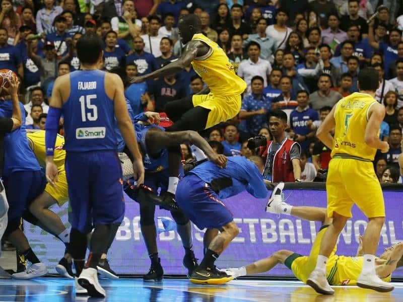 Thon Maker attempts to kick a Philippines basketball player.