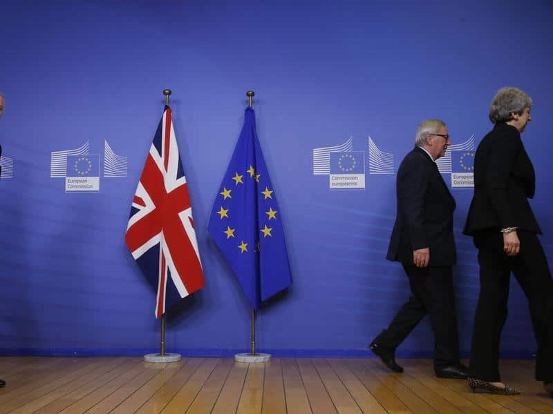 A file image of Michel Barnier, Jean-Claude Juncker and Theresa May