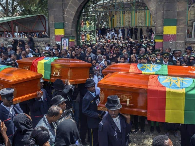 Relatives weep over empty caskets at a mass funeral for the Ethiopian Airlines crash victims. 