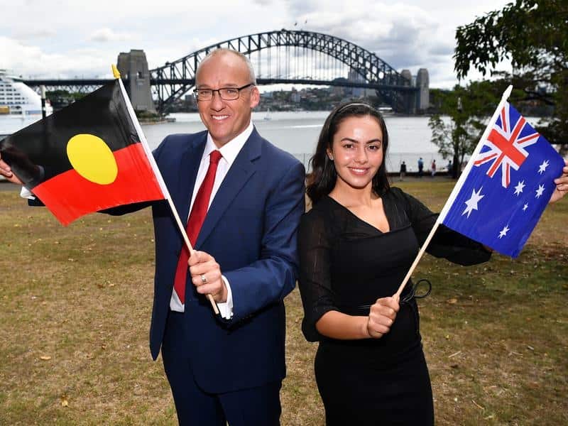 Luke Foley and Cheree Toka hold Australian flags in Sydney.