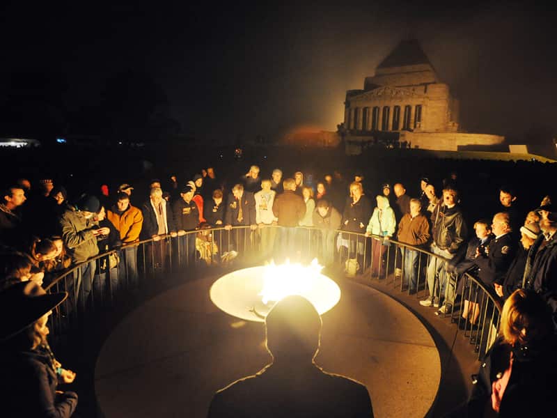 Melbourne's Shrine of Remembrance is shrouded in mist as rugged-up crowds gather ahead of the ANZAC Day dawn service (AAP).