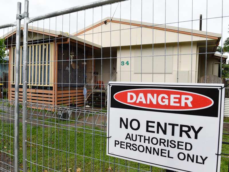 A fence surrounds a house