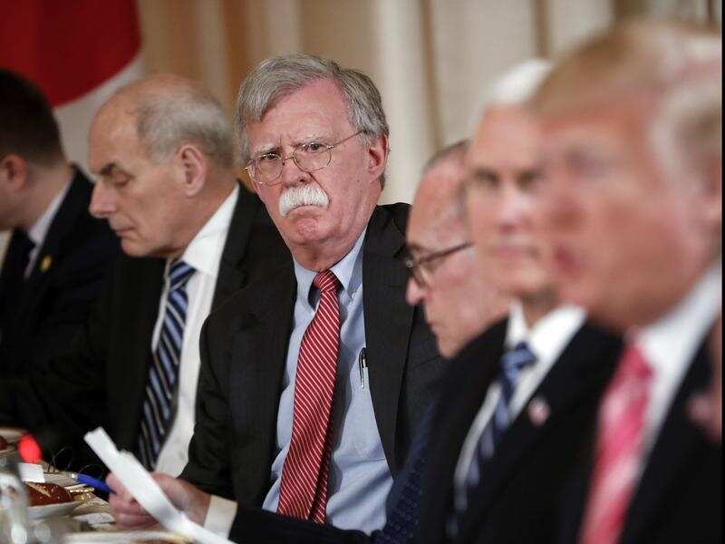 National security adviser John Bolton listens as the president talks