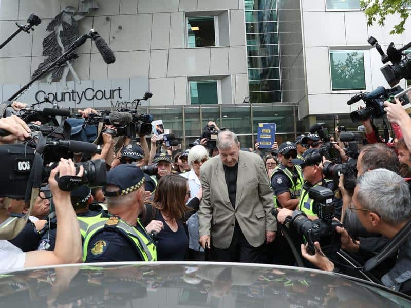 George Pell leaves court.