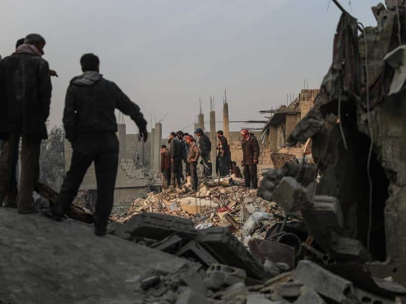 Volunteers search for survivors after several air strikes in Syria