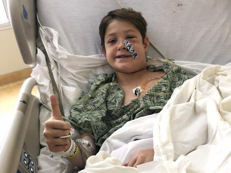 Xavier Cunningham gives the thumbs-up in hospital.