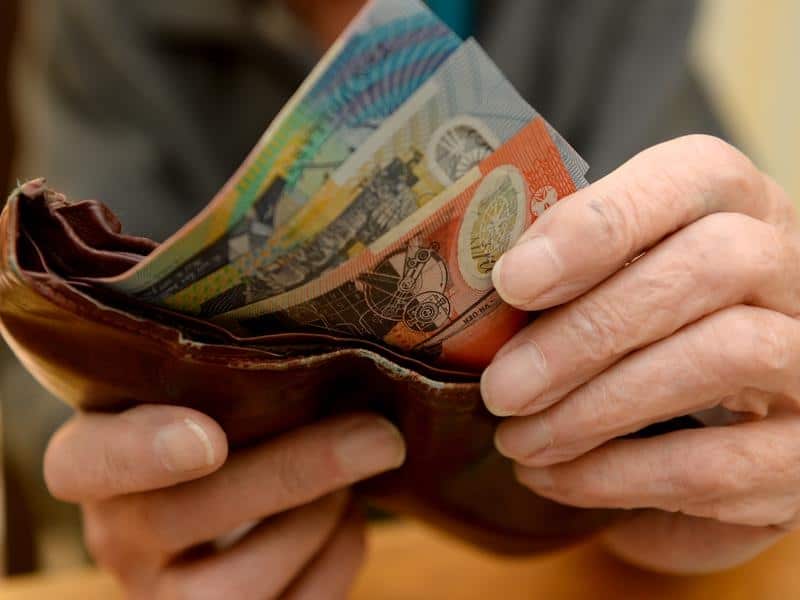 Money is taken out of a wallet.
