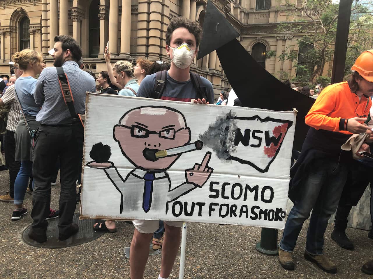 A protester expresses frustration with Scott Morrison's climate policy during the bushfire season.