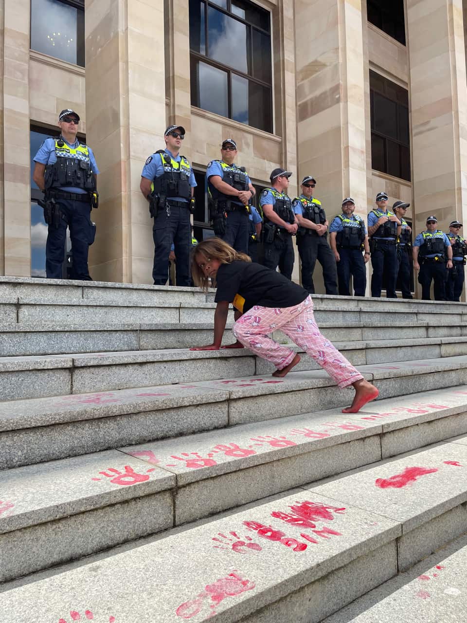 Demonstrators painted red hands on the steps of WA's parliament.