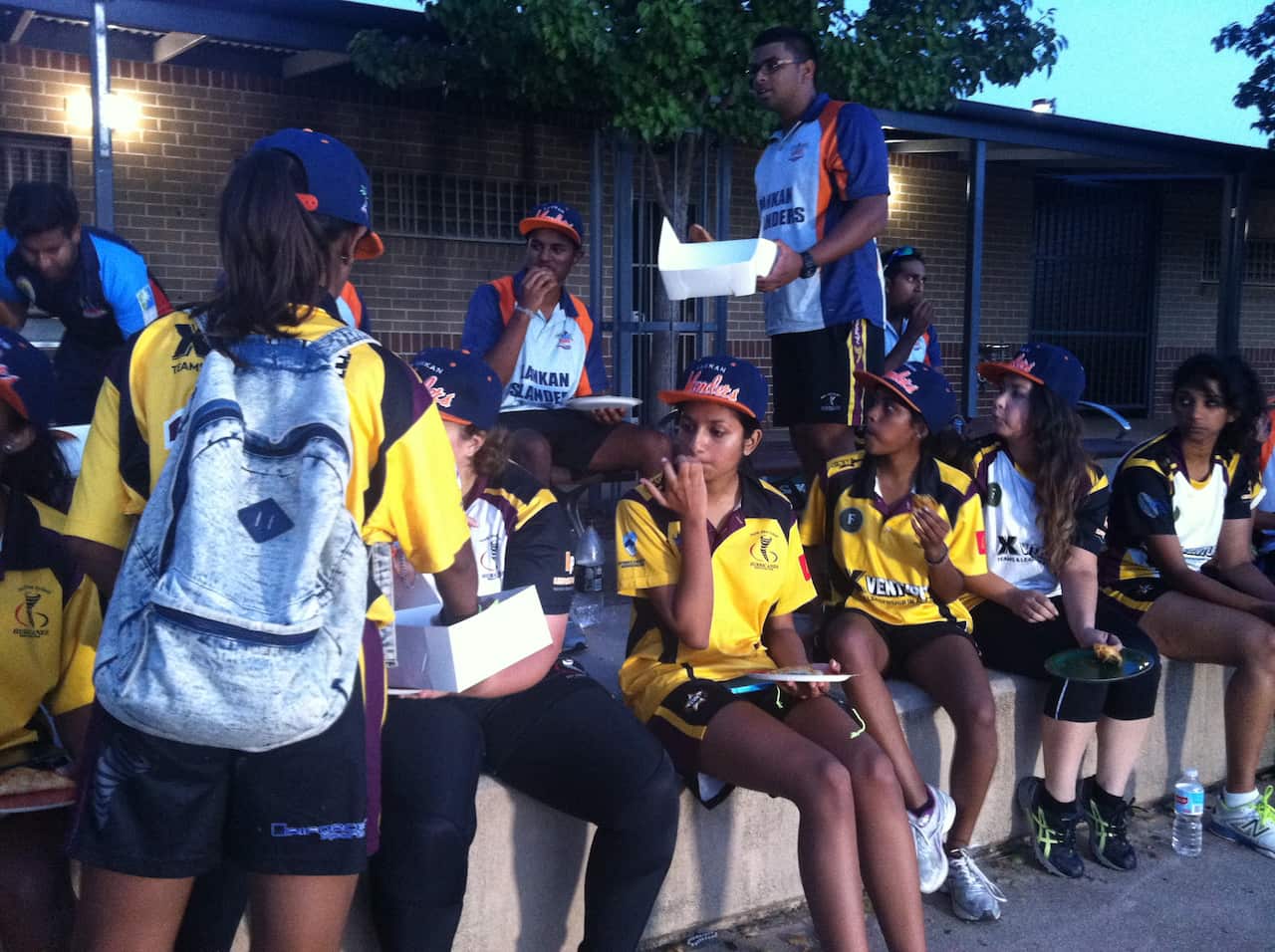 The men’s and women Lankan Islanders teams enjoying some Sri Lankan food after training.