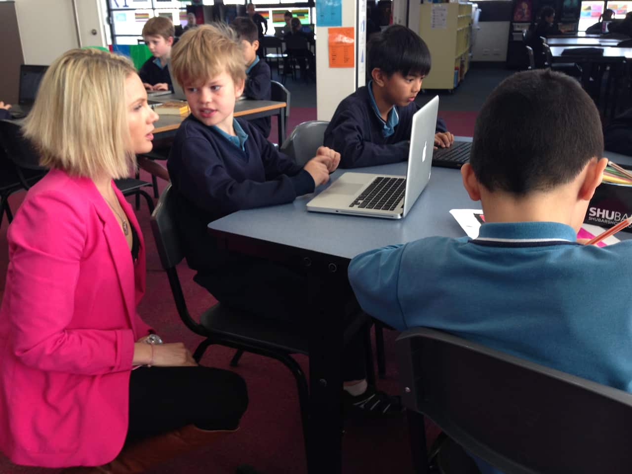 Students at Cranbourne East Primary School in Victoria speak to their teacher. (SBS)