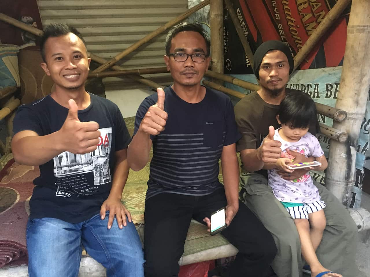 Mohummad In’am, who runs the cafe, centre, with Azhar and Al Faluty. 