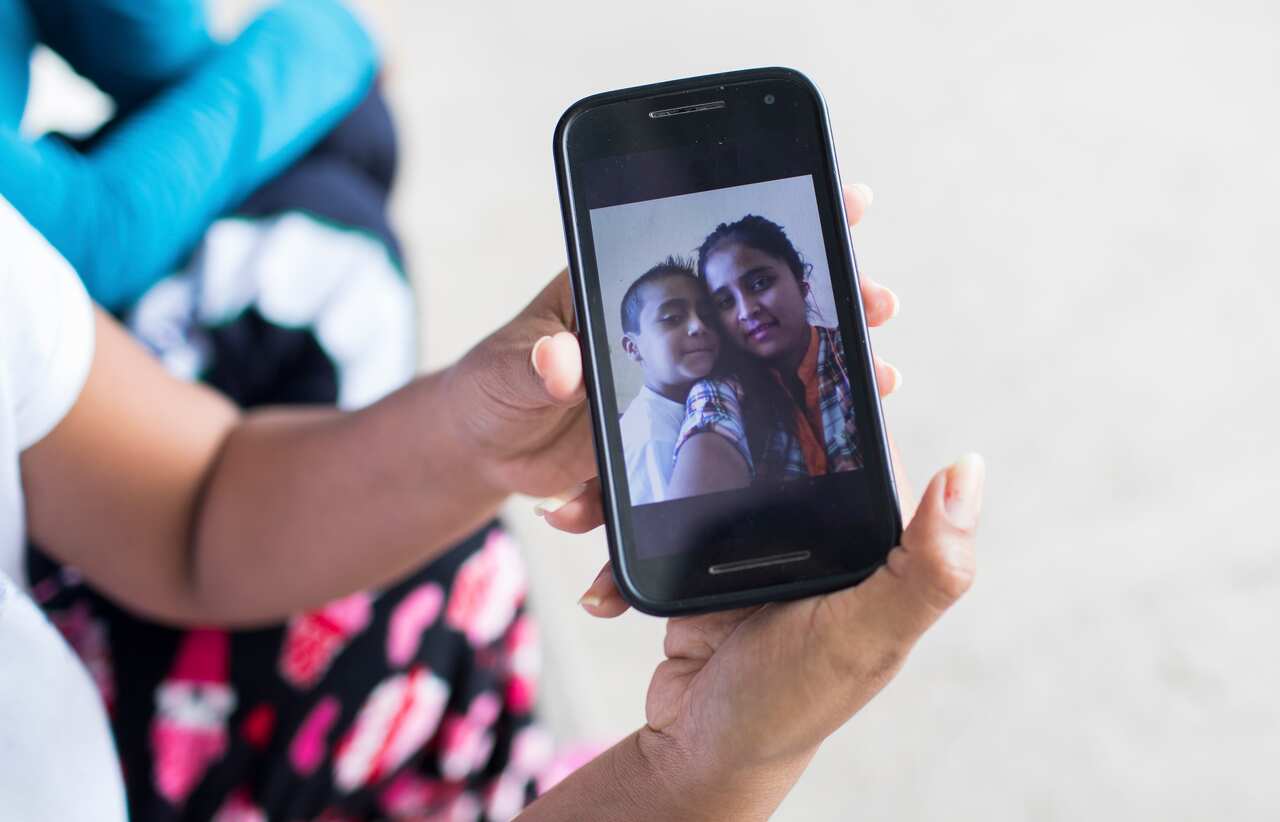 Elsa Johana Ortiz Enriquez shows a picture of herself with her son, in San Mauricio, Guatemala, June 15, 2018. 