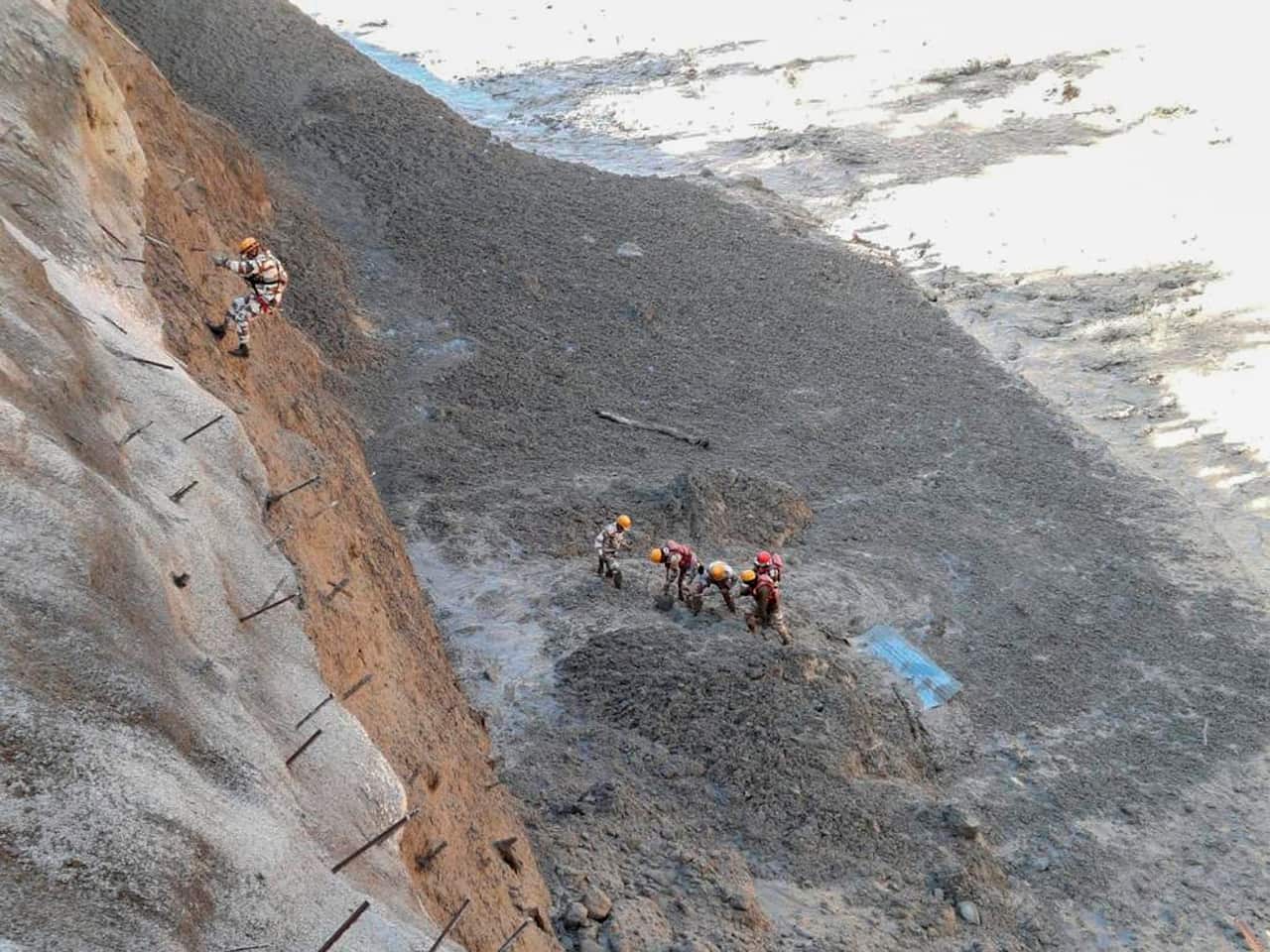 Personnel begin rescue work after a portion of the Nanda Devi glacier broke off, crashing into a dam.