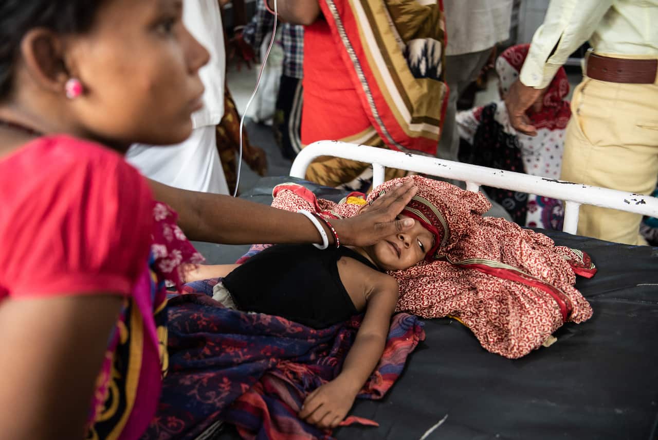 Gayatri Devi soothes her son, Anshu Kumar, 3, at Sri Krishna Medical College and Hospital in Muzaffarpur, India, June 25, 2019. Anshu was recovering from what many call “the lychee disease,” which causes high fever and brain swelling that leads to convuls