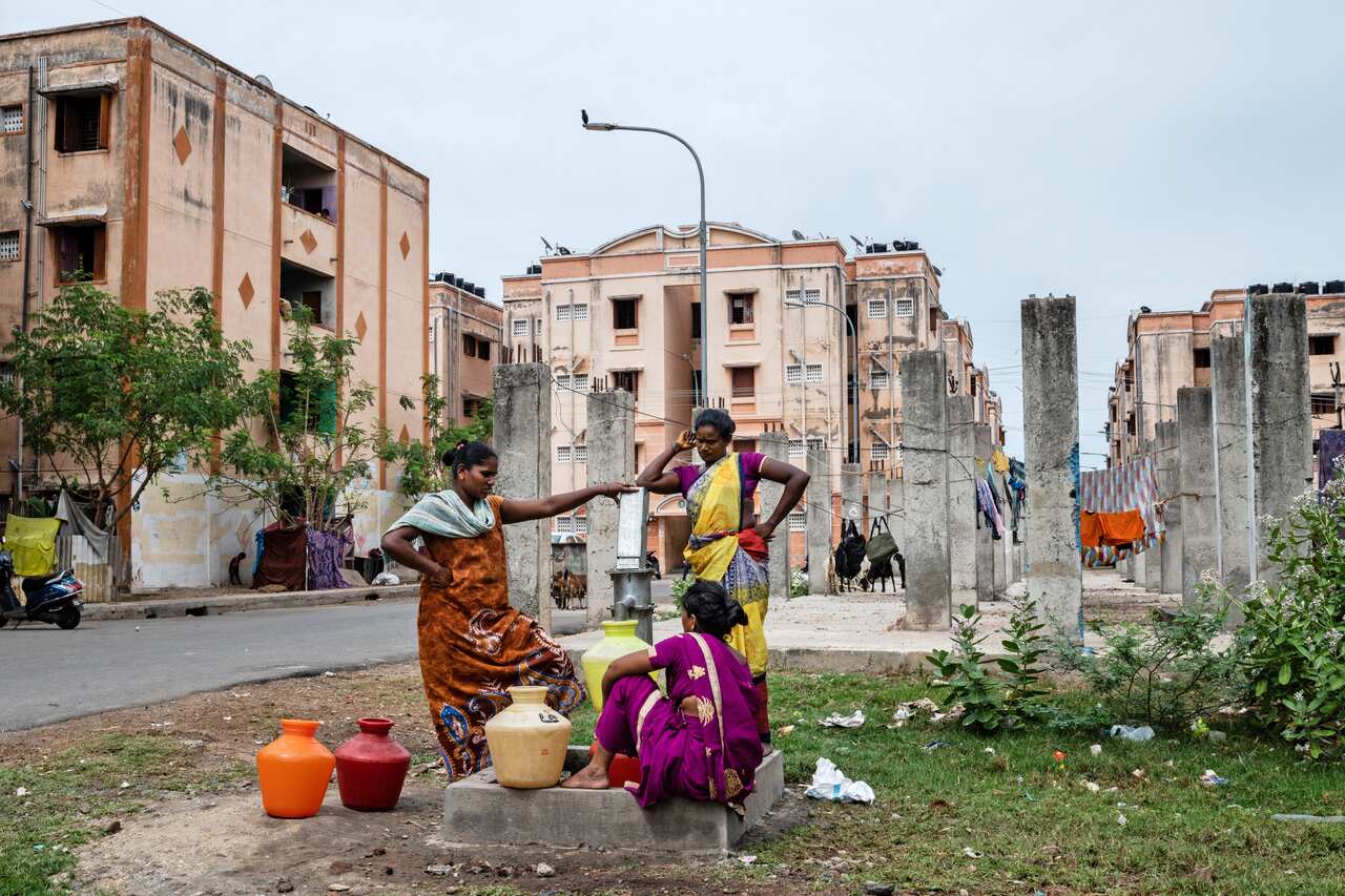 Residents use a hand-pump to collect water at an apartment complex whose buildings are not connected to a central water supply in the OMR district of Chennai, India.